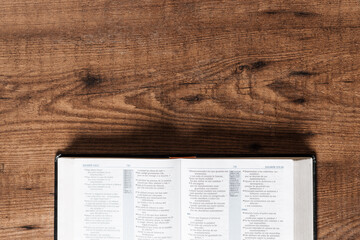An open Bible on a wooden table, copyspace, flat lay bible
