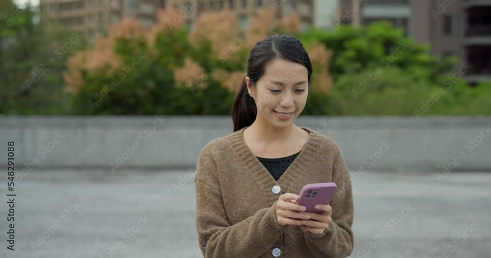 Wall mural woman use mobile phone at outdoor