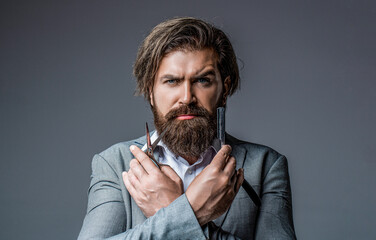 Barber scissors and straight razor, barber shop, suit. Vintage barber shop, shaving. Bearded client visiting barber shop. Portrait bearded man. Vintage barbershop