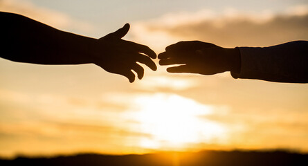 Outstretched hands, salvation, help silhouette, concept help. Giving a helping hand. Rescue,...