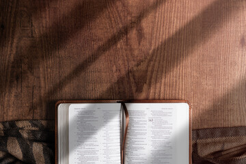 An open Bible on a wooden table, copyspace, flat lay bible