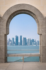 View of corniche skyline through the arcade in Doha, Qatar.