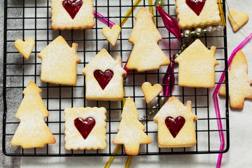 Sugar cookies stuffed with raspberry jam on a light background. Christmas and New Year's decor.