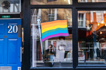 LGBTQ Rainbow flag on the window of a bar in London, England