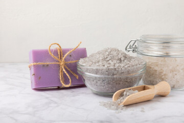 Lavender flowers, fragrant sea salt and handmade soap. The concept of spa, beauty and health salon, skin care cosmetics. Natural cosmetics.Aroma procedures. Close up photo on white wooden background.