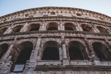 Low angle of the Colosseum amphitheater building in Rome with beautiful architecture - Powered by Adobe
