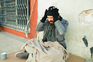 Naklejka premium Depressed homeless man concerned about money and food