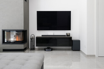 Detail of modern living-room in modern apartment - wall with TV and fireplace