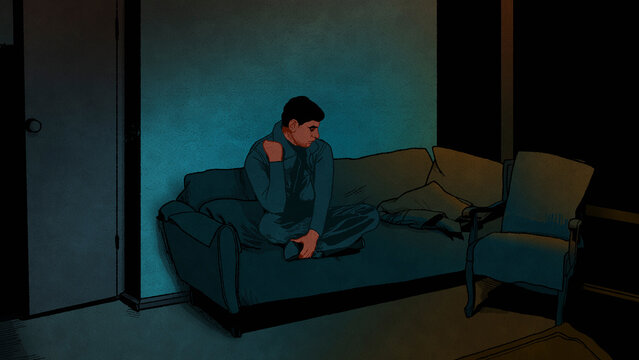 Depressed man sitting in dark room
