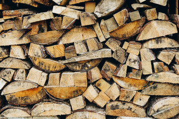 Many wooden logs stacked in a row