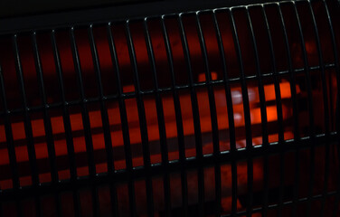 Electric heater abstract close-up shot on black background. High energy prices cause problems with...