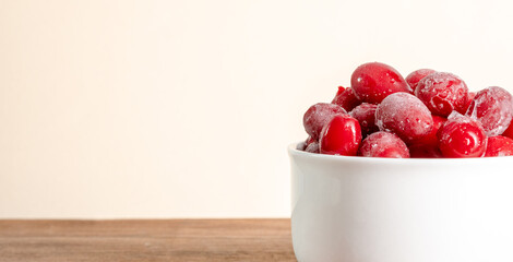 Frozen dogwood on a wooden background. Freshly frozen dogwood berry for compote, juice