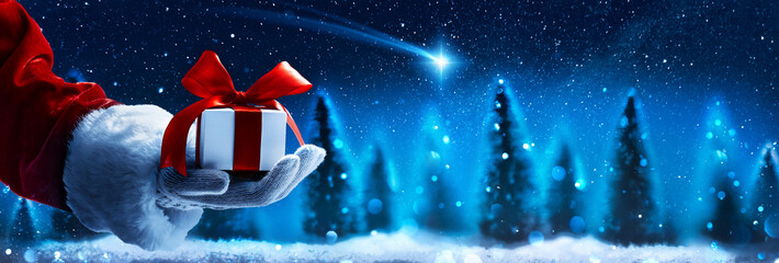 Christmas present from Santa Claus. Night starry sky with falling Christmas star - 548297870