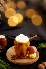 Aesthetic Viennese coffee with whipped cream, cinnamon and cardamom among Christmas decorations. Christmas traditional drink