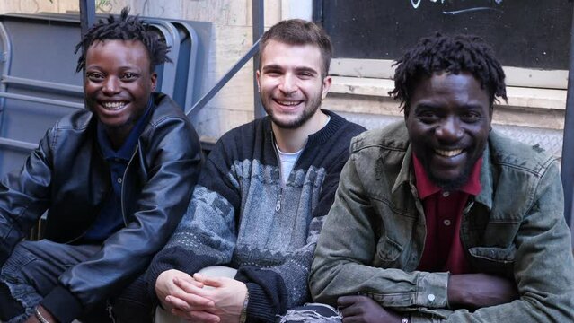 multiethnic smiles - witty guys of different ethnicity laugh at camera