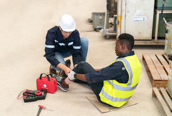 Robotics engineer working on maintenance of modern robotic arm in factory warehouse