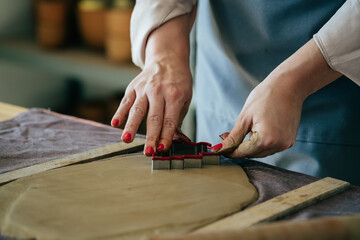 Close Up Photo Of Woman Hands Holding And Making Christmas Ornaments Of Clay At Her Workshop