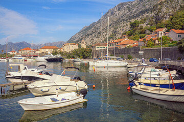 Fototapeta na wymiar Beautiful autumn mediterranean landscape. View of Bay of Kotor and Old Town of Kotor. Yachts and fishing boats. Montenegro, Adriatic Sea