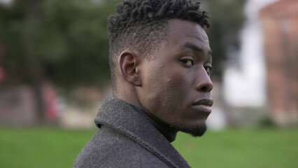 Serious elegant black African man standing outside, circling tracking shot