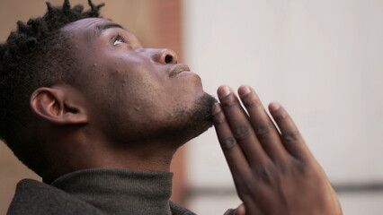 Religious young black man praying to God. African person looking up at sky with HOPE and FAITH2