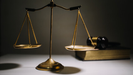 Business and lawyers discussing contract papers with brass scale on desk in office. Law, legal services, advice, justice and law concept