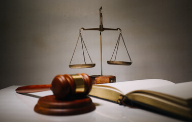 Business and lawyers discussing contract papers with brass scale on desk in office. Law, legal...