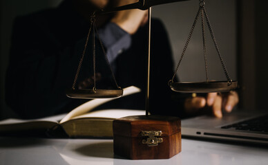 Business and lawyers discussing contract papers with brass scale on desk in office. Law, legal services, advice, justice and law concept