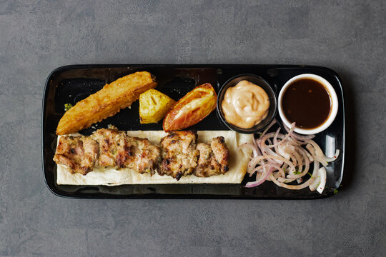 Chicken Reshmi tikka boti Kabab with chili sauce, dip and onion served in dish isolated on table top view of asian and indian food
