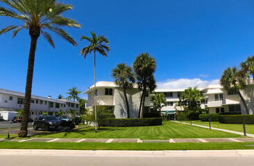 Fototapeta na wymiar Modern apartment buildings with palm trees at Miami - view from road