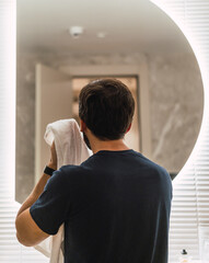 Fototapeta premium Man cleaning his face in the bathroom. facial care