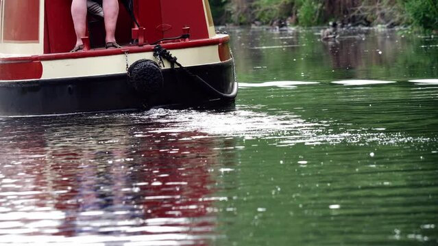 Barge on canal waterway in England on summer day wide shot