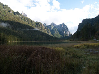 Autumn morning after the rain by the lake of Dobbiaco(Toblacher See). South Tyrol, province of Bolzano. Dolomites, Italy.