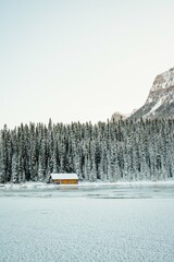 Isolated Cabin on Ice in Snowy Mountains