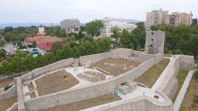 Aerial view of Medieval Citadel of Severin in Drobeta-Turnu Severin city, Romania. Footage was shot from a drone while flying backwards from the citadel on the Romanian bank of Danube river.