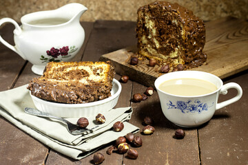 Delicious homemade marble pound cake and hazelnuts with a coffee milk cup 
