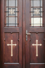 Entry of a church with cross on the door - 548319097