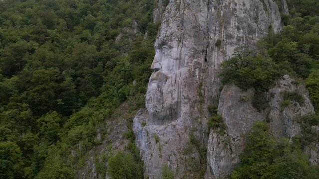 Aerial video of the statue of Decebal, located on the gorges of Danube river in Romania. Video was shoot from a drone with camera lowered with the statue in the view.