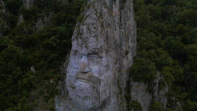 Aerial video of the statue of Decebal, located on the gorges of Danube river in Romania. Video was shoot from a drone with camera lowered with the statue in the view.