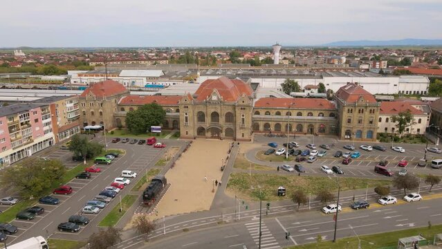 Aerial view of the train station in Arad city, Romania. Footage was shot from a drone at a lower altitude while flying forward towards the main building.