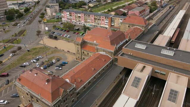 Aerial view of the train station in Arad city, Romania. Footage was shot from a drone at a lower altitude while flying in a circular way around the building with the camera gimbal lowered.
