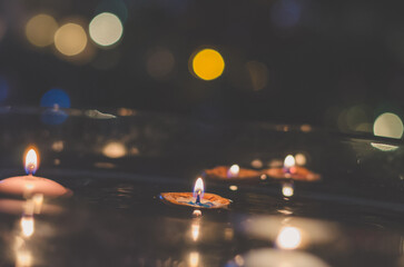 symbolic christmas tradition with candles in nutshell floating on water,