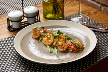 Grilled shrimps with sauce and herbs served in restaurant