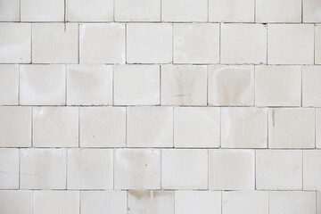 Hollow bricks wall with grey cement on construction site pattern background