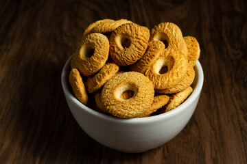 Ring Coconut biscuits served in a bowl. Brazilian little donut. Selective focus.