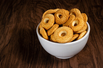 Ring Coconut biscuits served in a bowl. Brazilian little donut. Selective focus.