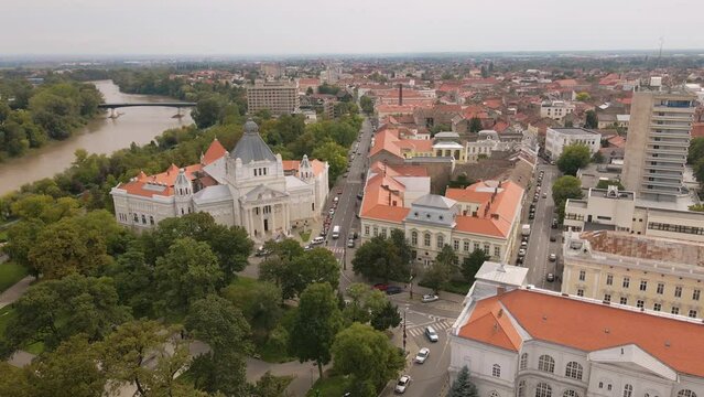 Aerial footage over Arad city center, in Romania, with the Administrative palace and Cultural palace in the view. Footage was shot from a drone while flying backwards and banking right.
