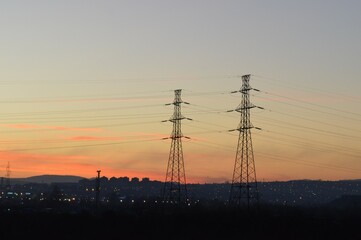 Fototapeta premium Silhouette of an electric tower for the transmission of high voltage electricity