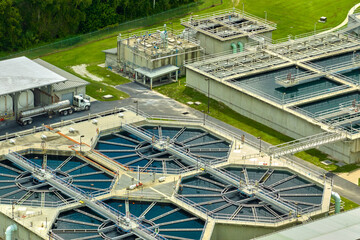 Aerial view of modern water cleaning facility at urban wastewater treatment plant. Purification process of removing undesirable chemicals, suspended solids and gases from contaminated liquid