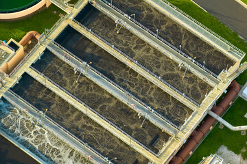 Aerial view of modern water cleaning facility at urban wastewater treatment plant. Purification...