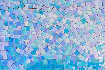Ceramic mosaic tiles with white, blue and turquoise squares laid out in a chaotic pattern.